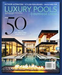Cover of Luxury Pools magazine featuring a modern house, pool, outdoor fire feature at dusk—perfect for your website.